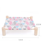 Cat lying on the raised canvas bed