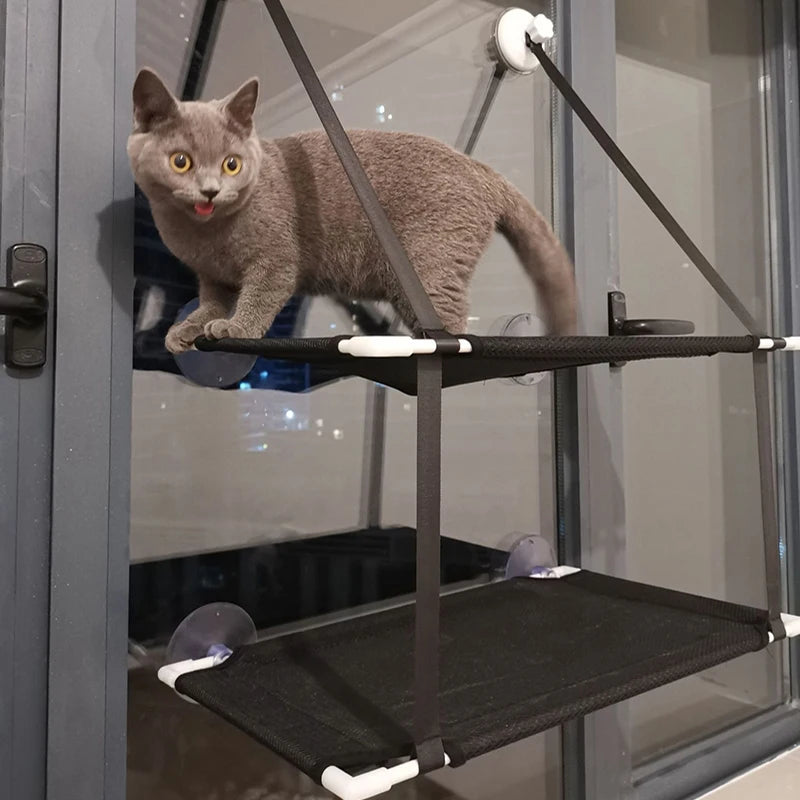 Two cats using the stacked window hammock