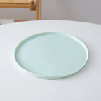 Silicone feeding mat with a raised lip